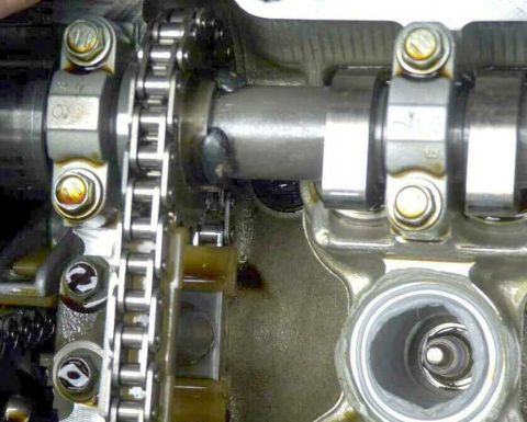 1997 Ford Taurus - Close-up view of an engine's internal timing chain and camshaft mechanism.