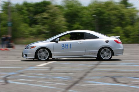 2001 Mercury Grand Marquis - A silver coupe with racing stripes and the number 381 on the door is captured in motion on a paved track.