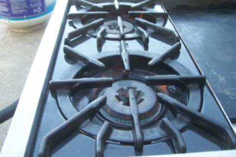 1994 Ford F-150 - This image shows a gas stove top with two burners lit.