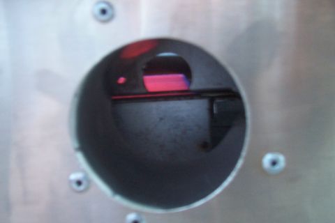 1994 Ford F-150 - A close-up view of a gauge with red and pink illumination, mounted on a brushed metal panel.