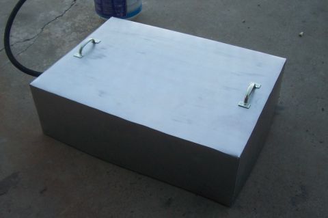 1994 Ford F-150 - A metal fuel tank with handles and a hose is shown resting on a concrete surface.