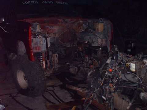 1982 Ford Bronco - This red truck shows its empty engine bay, with the engine and much of the front-end wiring removed.