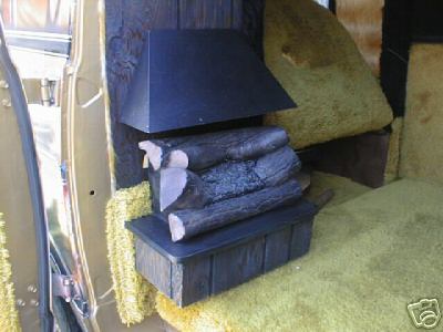 1978 Ford E250 - The interior of a van shows a decorative fireplace with faux logs and yellow shag carpeting.