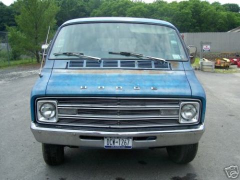 1978 Ford E250 - This blue Dodge van has a distinctive grille and chrome bumper, with a license plate visible.