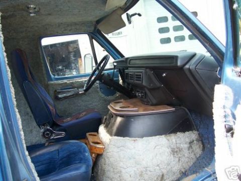 1978 Ford E250 - Interior view of a 1978 Ford E250 van, showing custom shag carpeting and blue upholstery.