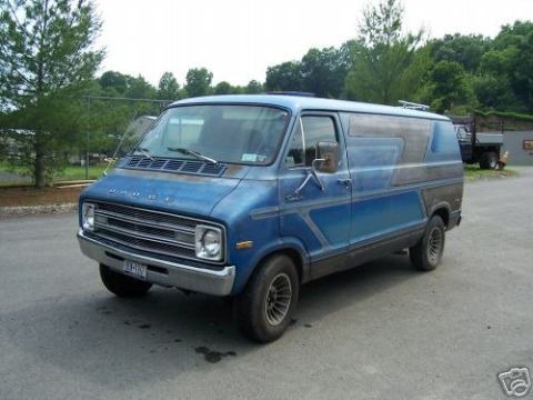 1978 Ford E250 - A blue 1977 Dodge van is shown from a three-quarter front angle, with visible custom graphics on its side.