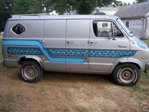 1978 Ford E250 - Customized van with blue flame graphics, diamond window, and aftermarket wheels.