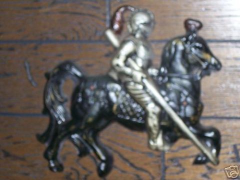 1978 Ford E250 - Figurine of a knight in armor riding a horse, mounted on a wooden surface.