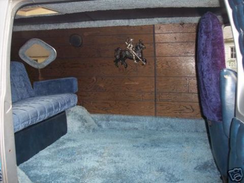 1978 Ford E250 - Van interior with custom upholstery and wood paneling, including a decorative knight on horseback.