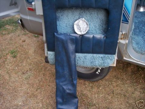 1978 Ford E250 - Interior view of a 1977 Dodge van, showing the door panel and a folded tarp.