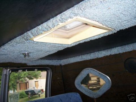 1978 Ford E250 - The interior of a van features a carpeted ceiling with a skylight and a decorative mirror.