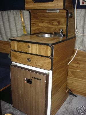 1978 Ford E250 - Interior view of a camper van's kitchenette, a sink and cabinetry.
