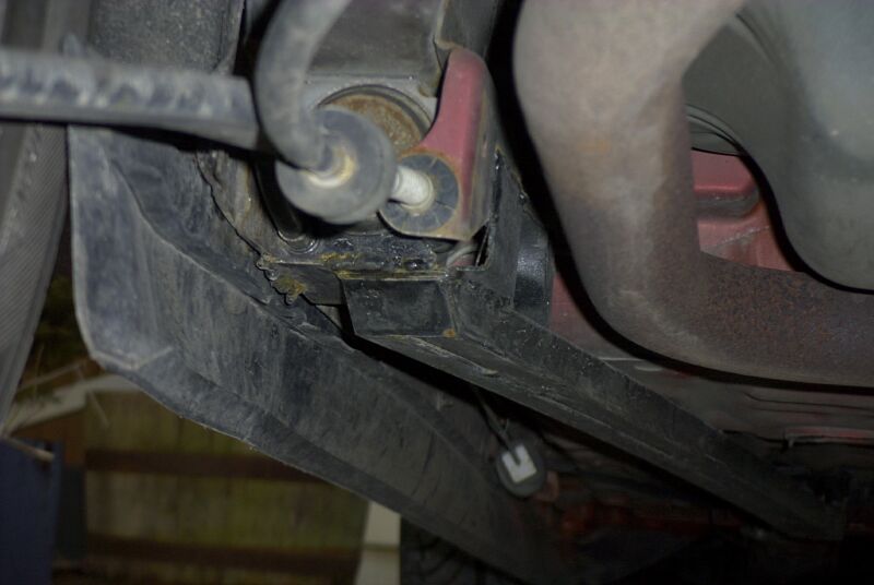 Welded-in box-section subframe connector under a car's rear floor pan