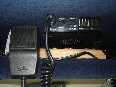 1978 Ford E250 - Close-up of a Cobra 20 Plus CB radio and microphone, likely installed in a vehicle's interior.