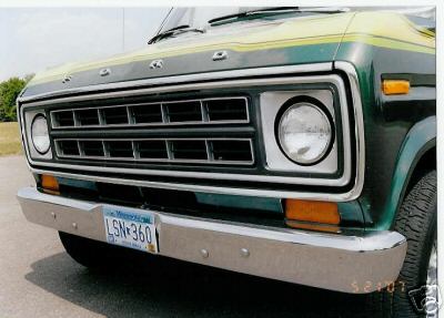1978 Ford E250 - The front grille and headlights of a green and yellow Ford van are visible.