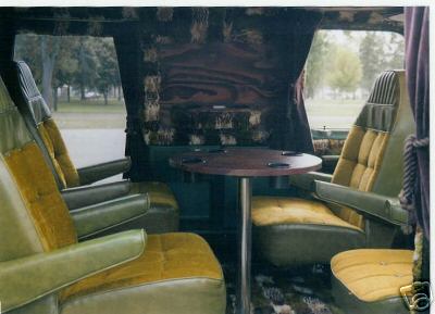1978 Ford E250 - Custom interior of a van features plush green and gold velour seating arranged around a central table.