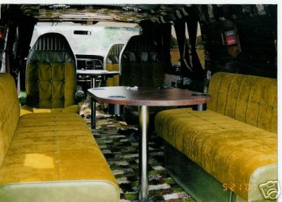 1978 Ford E250 - Custom van interior features plush seating, a table, and captain's chairs visible in the front.