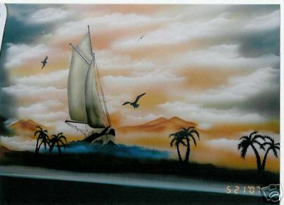 1978 Ford E250 - A sailboat navigates the ocean waves under a cloudy sky with palm trees and mountains in the background.