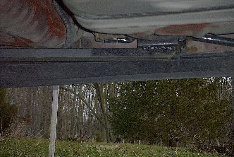 Underside view of welded subframe connector along a car's rocker and floor pan