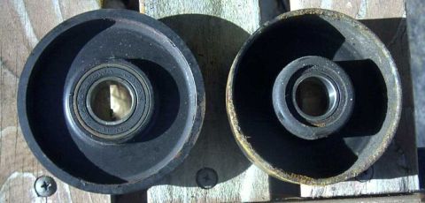 1997 Ford Taurus - Two idler pulleys are shown, each containing a bearing. One pulley is in better condition than the other.