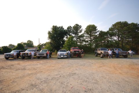 1996 Ford Bronco - Several Ford Bronco and F-Series trucks gathered together on a sunny day.