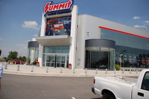 1996 Ford Bronco - The entrance of a Summit Racing Equipment store is shown on a sunny day.