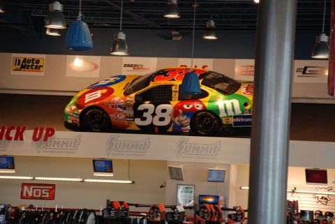 1996 Ford Bronco - A colorful M&M's #38 race car is displayed indoors, likely in a retail setting.