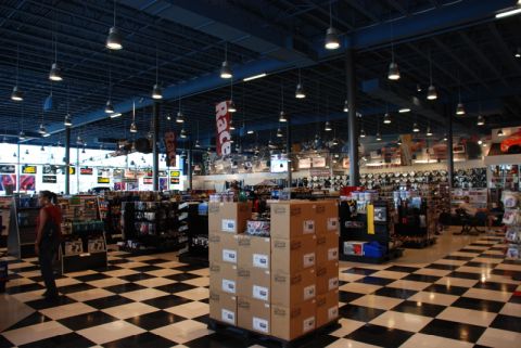 1996 Ford Bronco - A wide shot of the inside of an auto parts store, showing aisles of merchandise and a distinctive black and white checkered floor.