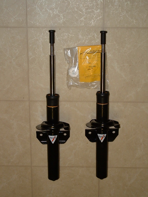 1992 Ford Taurus - Two Koni shock absorbers are shown with their installation instructions and hardware, against a tiled background.