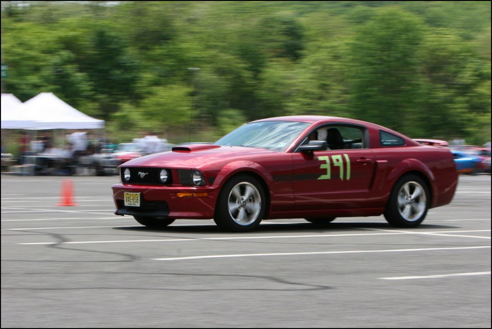 Red Ford Mustang with racing number 391 on door, seen from 3/4 front angle