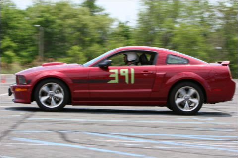 2001 Mercury Grand Marquis - A red coupe with racing numbers participates in an autocross event.