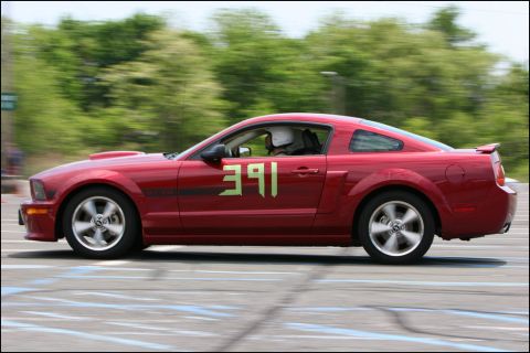 2001 Mercury Grand Marquis - A red coupe with racing numbers 391 on its door is captured in motion, likely during an autocross event.