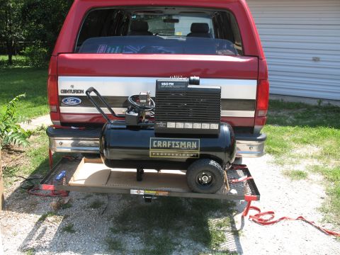 1994 Ford C-150 (Centurion Conversions) - 1994 Ford C-150 (Centurion Conversions) with an air compressor loaded on a trailer.