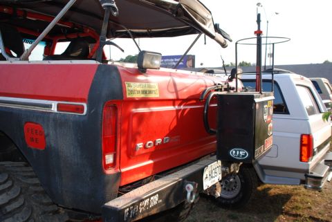 1996 Ford Bronco - Rear view of a red Ford Bronco with black trim and large tires.