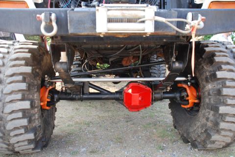 1996 Ford Bronco - Close-up view of the heavily modified rear axle and suspension of an off-road vehicle.