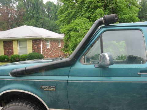 1996 Ford Bronco - A teal 1996 Ford Bronco is shown from the side, equipped with a snorkel air intake.