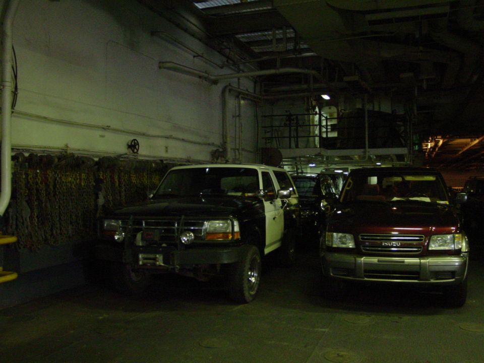 1994 Ford Bronco and Isuzu Trooper parked inside cargo area