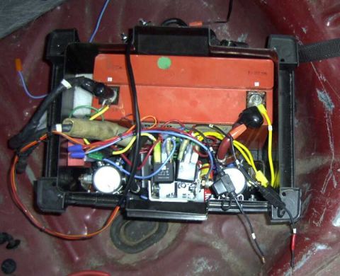 1997 Ford Taurus - The complex electrical wiring for a vehicle's battery system is shown in this close-up view.