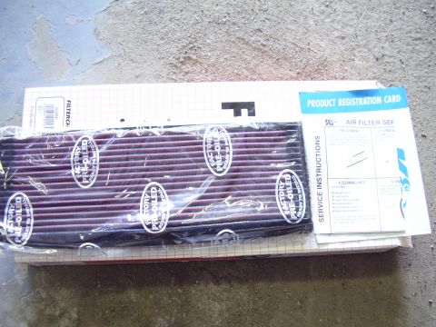 1996 Dodge 2500 - A new K&N air filter is shown with its accompanying paperwork on a concrete surface.
