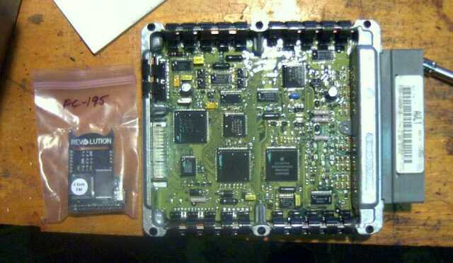 Engine control module with a small chip in a bag labeled PC-195