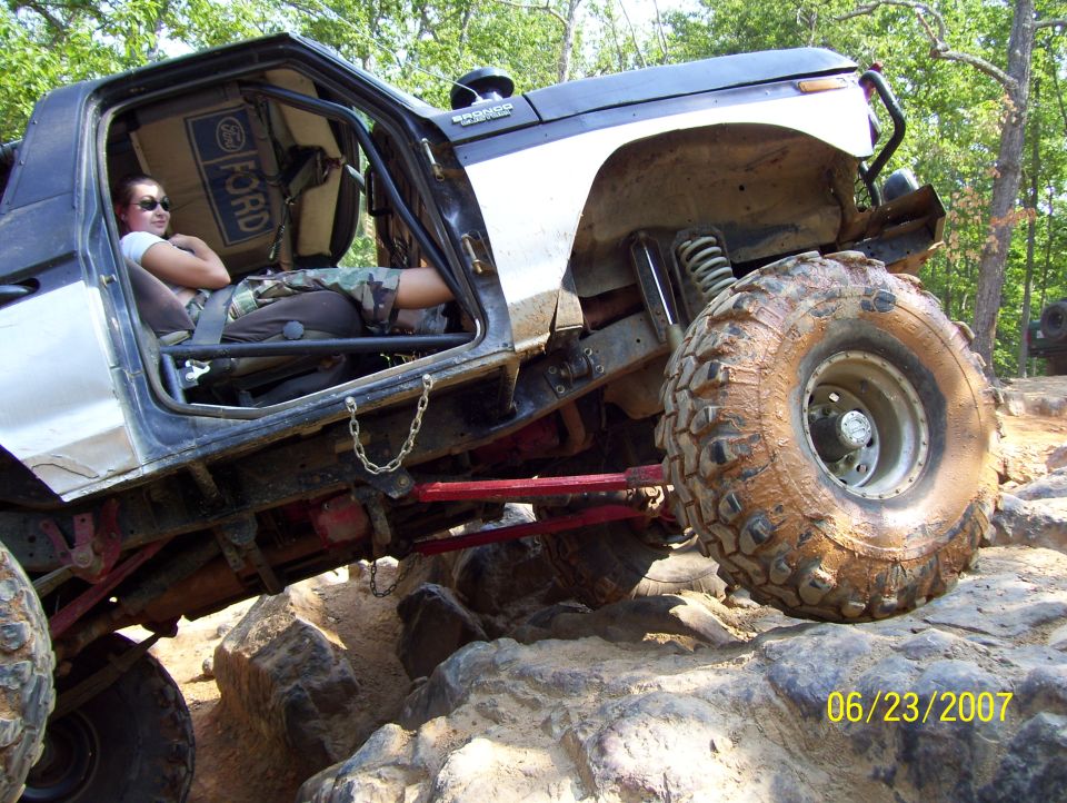 1978 Ford Bronco on rocks with driver inside, modified for off-roading