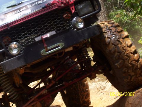 1978 Ford Bronco - This off-road vehicle is covered in mud, showing its suspension and large tires.