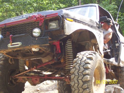 1978 Ford Bronco - A heavily modified off-road vehicle, possibly a Bronco, is shown with extensive suspension upgrades and off-road equipment.