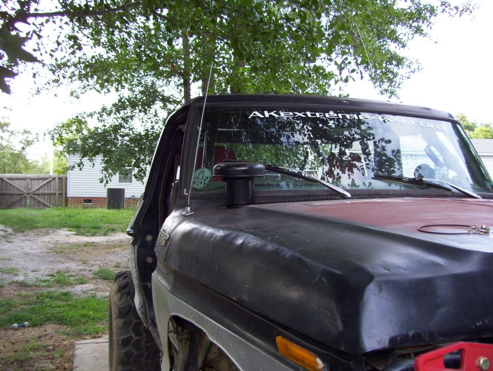 Front of a black Ford Bronco with a snorkel on the hood. Sticker on windshield says AKextreme4x4.com. Supermotors.net logo at bottom right