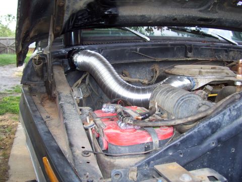1978 Ford Bronco - Custom snorkel intake system installed in the engine bay of an older vehicle.
