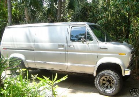 1978 Ford E250 - Passenger-side profile of a silver Ford Econoline panel van with blank cargo sides, chrome side molding, amber side marker and a body-side…