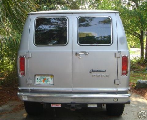 1978 Ford E250 - Rear view of a silver 1978 Ford E250 van parked outdoors with trees in the background.