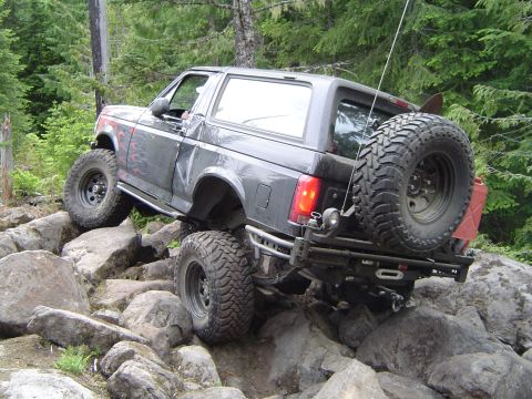 1989 Ford Bronco - Modified 1989 Ford Bronco navigating a difficult rocky terrain.