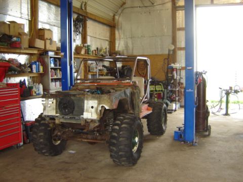 1992 Ford Bronco - This heavily modified vehicle is in a garage, possibly undergoing repairs or customization.