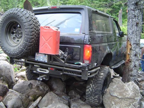 1989 Ford Bronco - This 1989 Ford Bronco is navigating a rocky trail with a spare tire and gas can mounted on the rear.